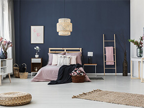 Dark Blue Bedroom Feature Wall with White Floorboards